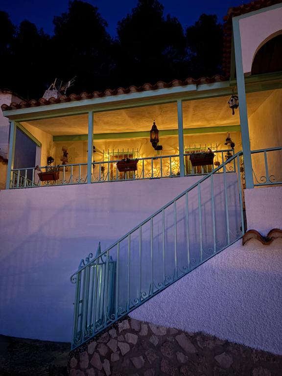 a balcony of a house at night at La casita del Cerro in Chinchilla de Monte Aragón