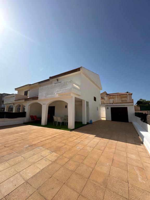 a large white building with a large patio at El Balcón de Villablancas in La Manga del Mar Menor