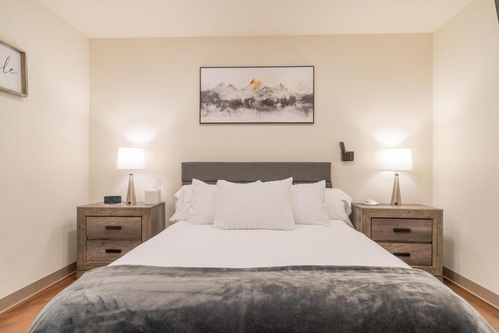 a bedroom with a large bed with two night stands at Modern City Suite 2 in Fairbanks