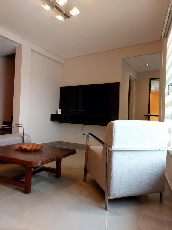 a living room with a couch and a table at Departamentos Rada in Rada Tilly