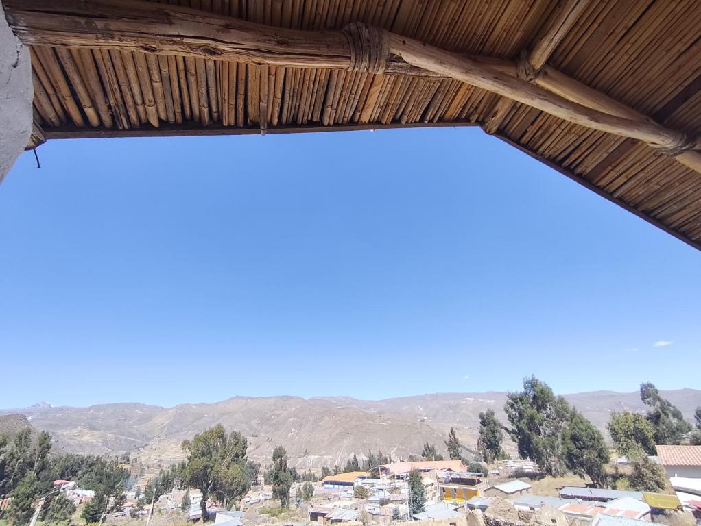 a view from the window of a building with mountains in the background at Lodge Wayra Wasi in Coporaque