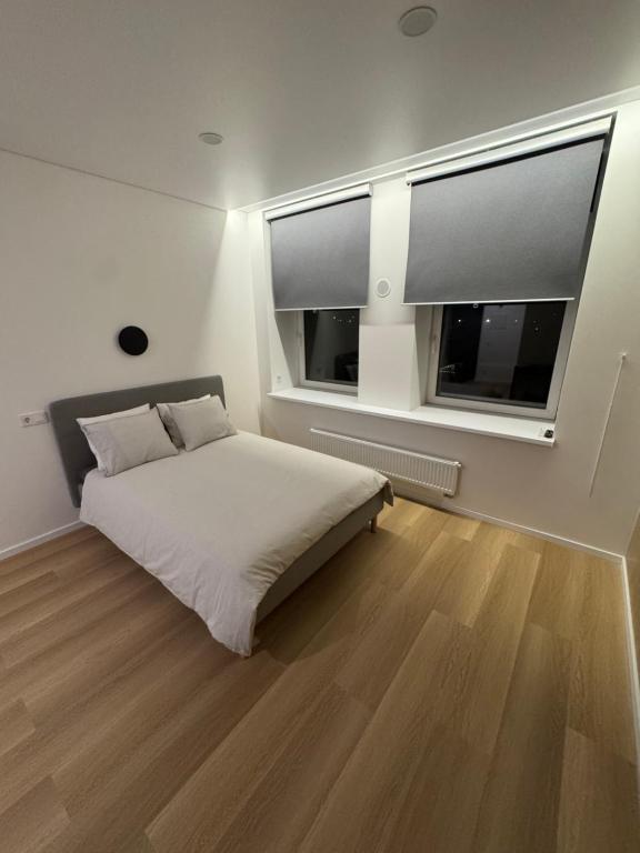 a bedroom with a bed and a large window at 10 New Airport Apartment in VNO