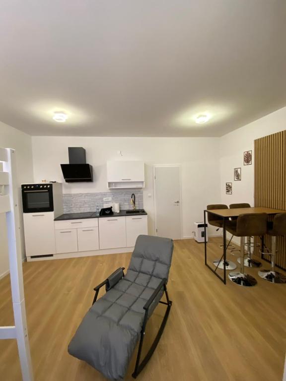 a living room with a chair and a table at NERi in Koper