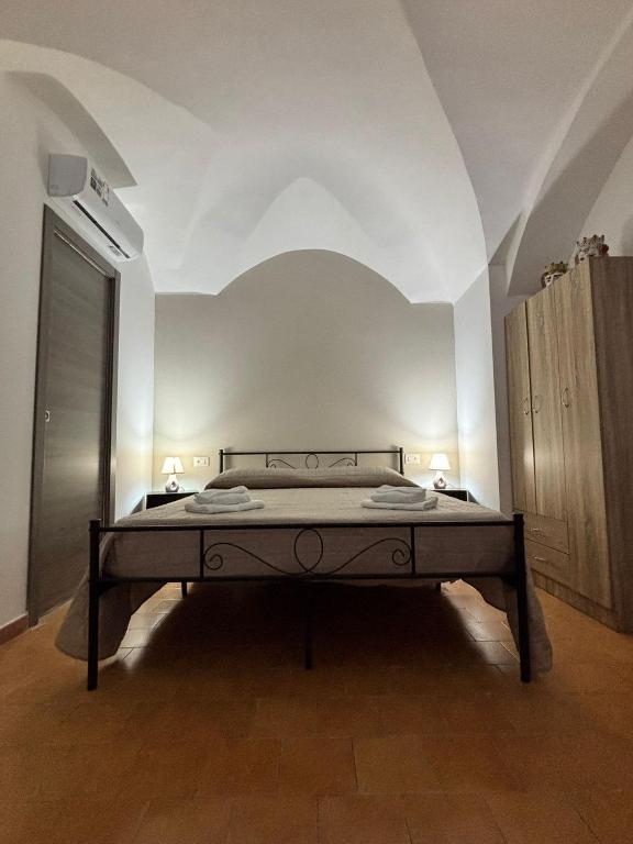 a bedroom with a bed in a white room at Arusticana al 393 in Catania
