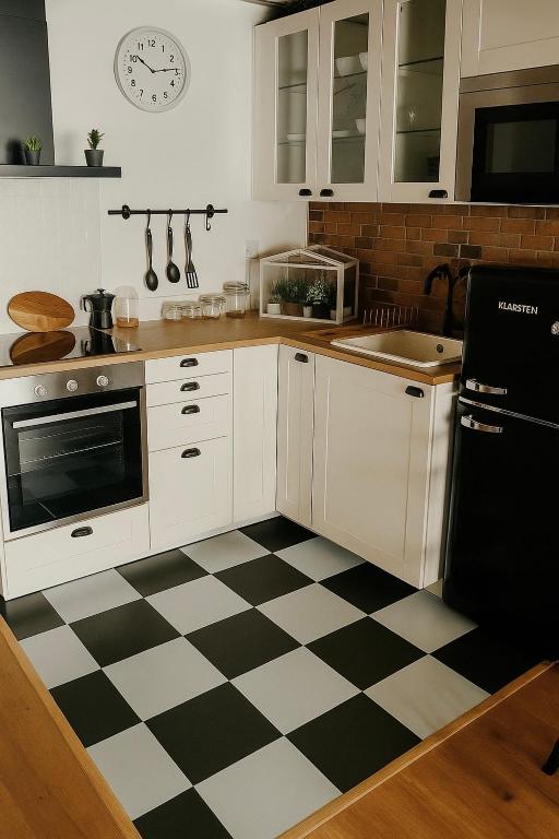 a kitchen with a black and white checkered floor at AL Belém 85 in Lisbon