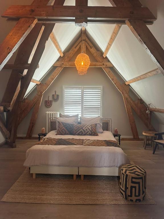 a bedroom with a large bed in an attic at African Cosy suite in The Hague