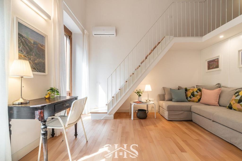 un soggiorno con un divano e un tavolo di Domu Chiara a Cagliari