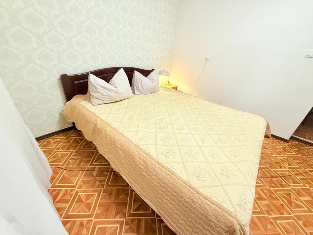 a bedroom with a large bed with white sheets and pillows at Одноместный номер на ключ в хостеле Single Hostel Room in Chişinău