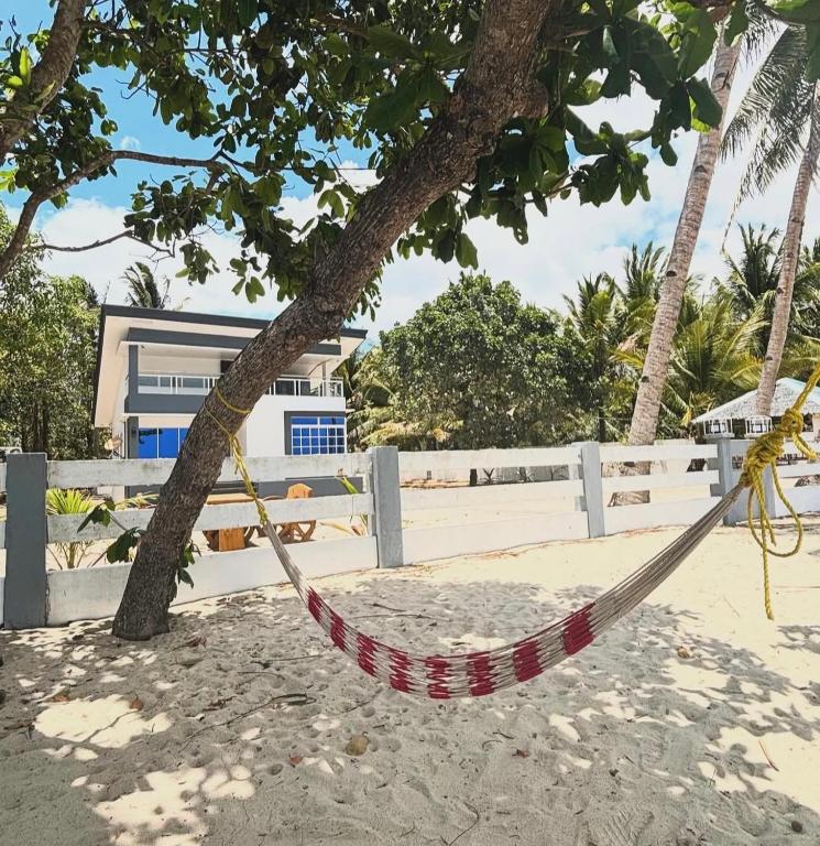 a hammock tied to a tree on the beach at Lui my happy place in Pandan
