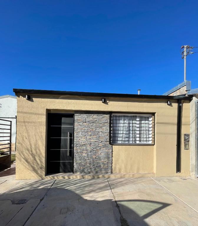 a building with a garage with a large door at Departamento Boulevard in Malargüe