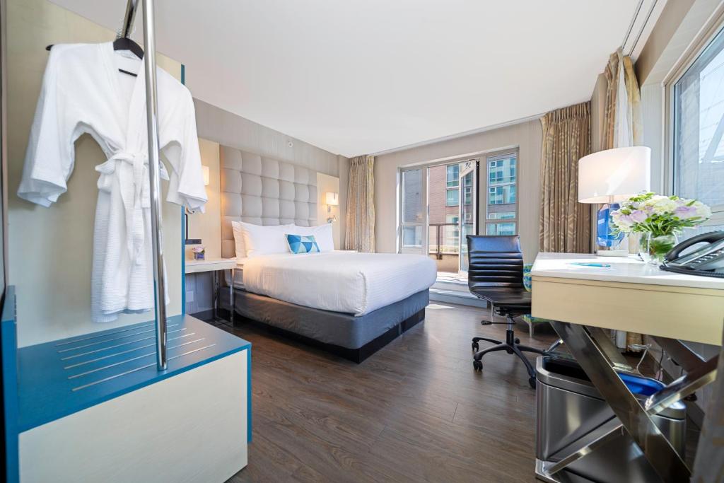 a hotel room with a bed and a desk at Hotel BLU in Vancouver