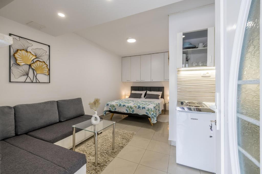 a living room with a couch and a bed at Studio Apartment Nikol in Split