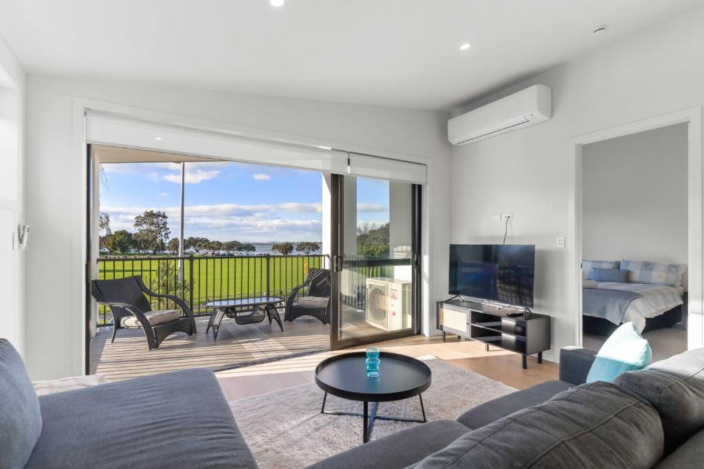 a living room with a couch and a television at Memorial View - Tauranga Holiday Home in Tauranga