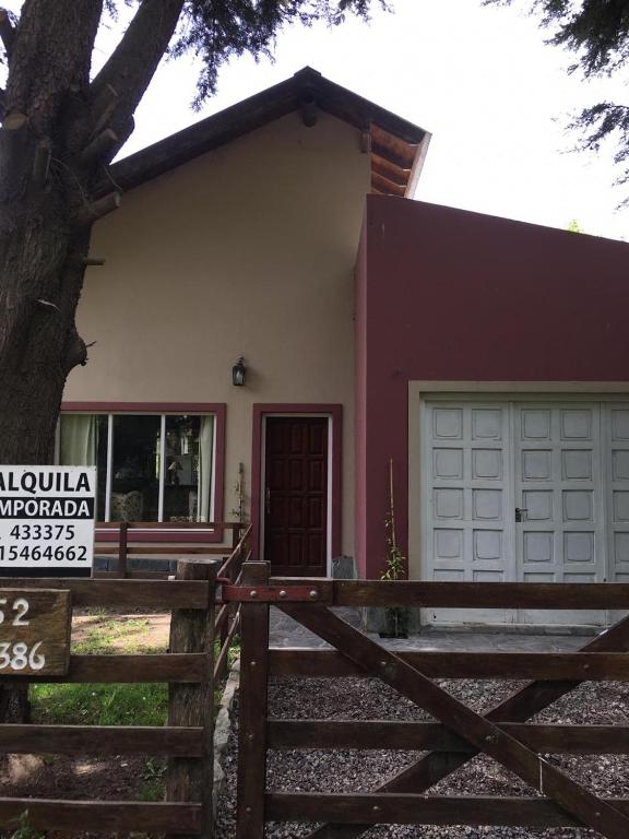 a house with a wooden fence in front of it at Villa Serena Deportista in Necochea