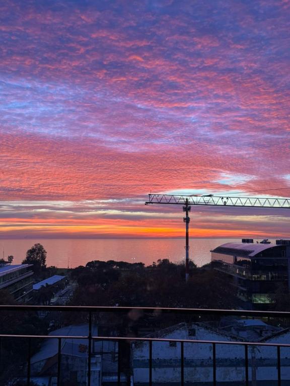 a sunset over the water with a crane at MONOAMBIENTE VISTA AL RIO in Florida