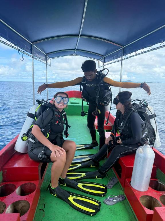 a group of people on a boat in the water at Famili Dive Shop in Mios Andau-besar