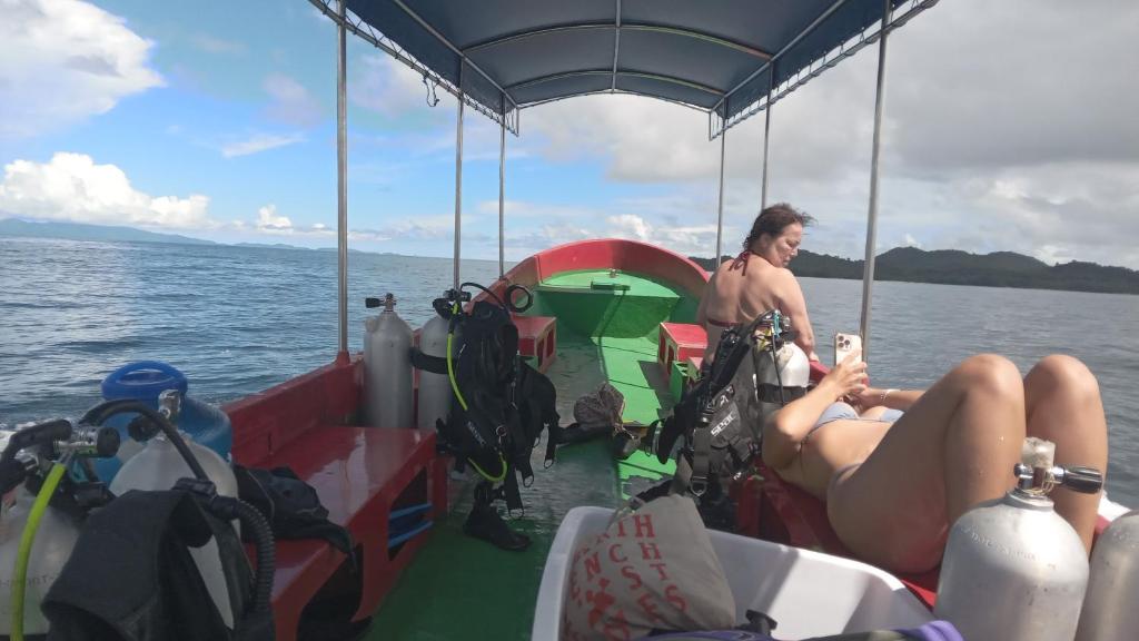 un hombre y una mujer sentados en un barco en Famili Dive Shop, 