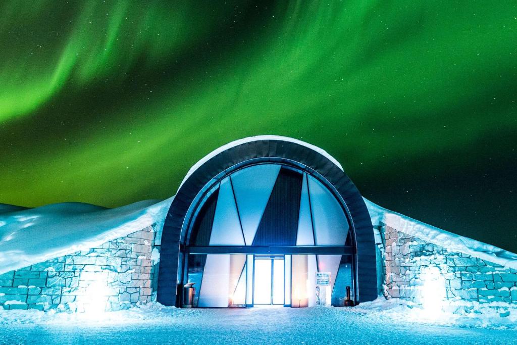 an igloo with the aurora in the sky at Ice Hotel in Jukkasjärvi