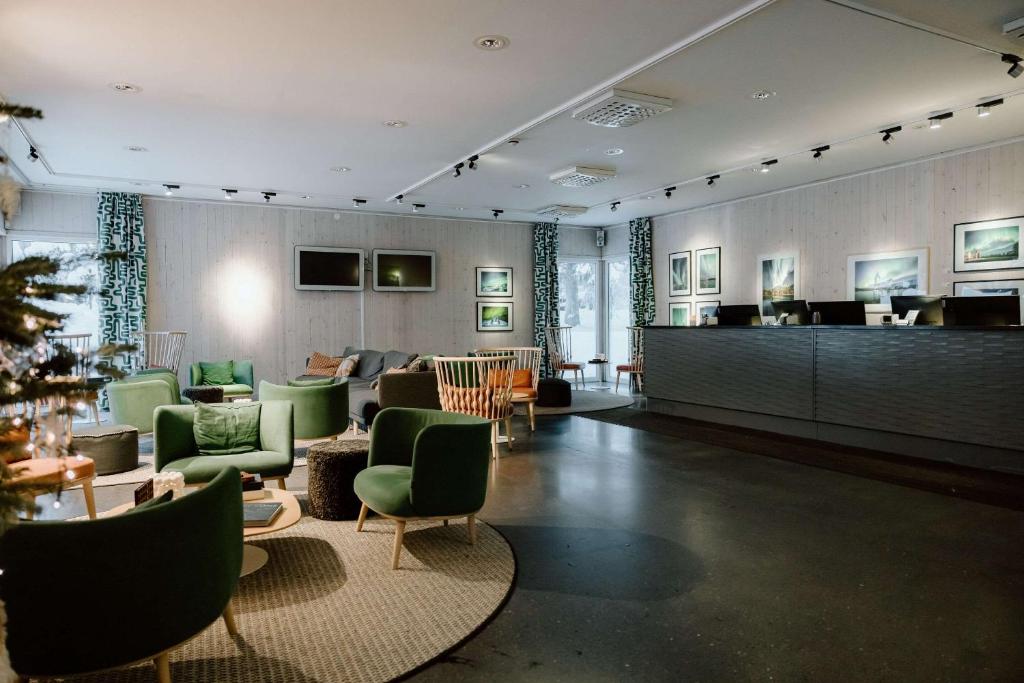 a large room with a lobby with green chairs at Ice Hotel in Jukkasjärvi