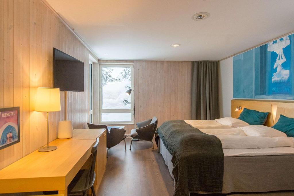 a hotel room with a bed and a desk at Ice Hotel in Jukkasjärvi