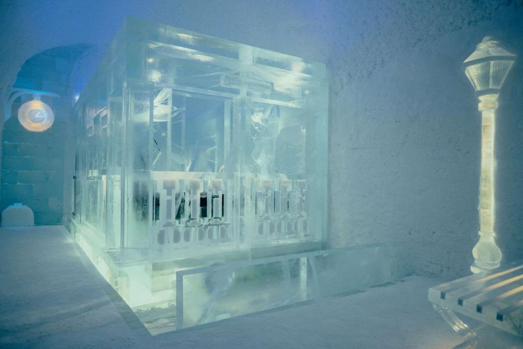 a room with a glass block window with a bench at Ice Hotel in Jukkasjärvi