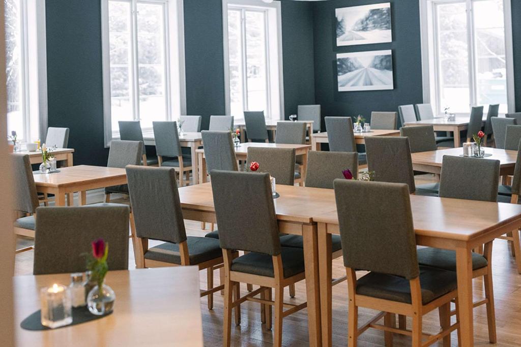 a dining room with wooden tables and chairs at Ice Hotel in Jukkasjärvi