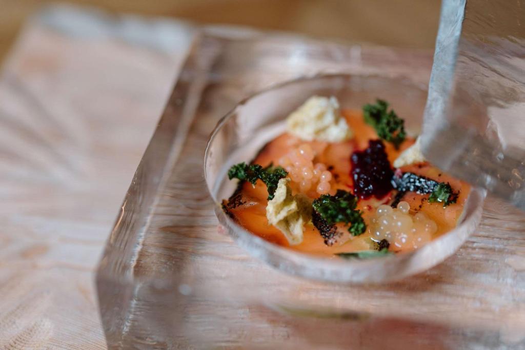 a small plastic bowl of food on a table at Ice Hotel in Jukkasjärvi