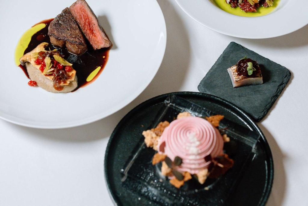 a table with a plate of food and a plate of desserts at Ice Hotel in Jukkasjärvi