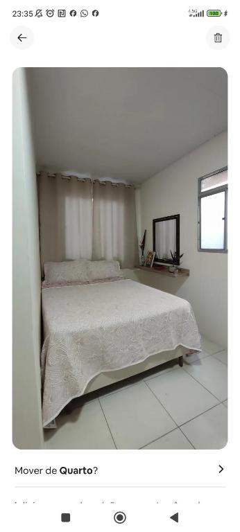 a bedroom with a bed in a white room at Espaço Sol e Mar in Salvador