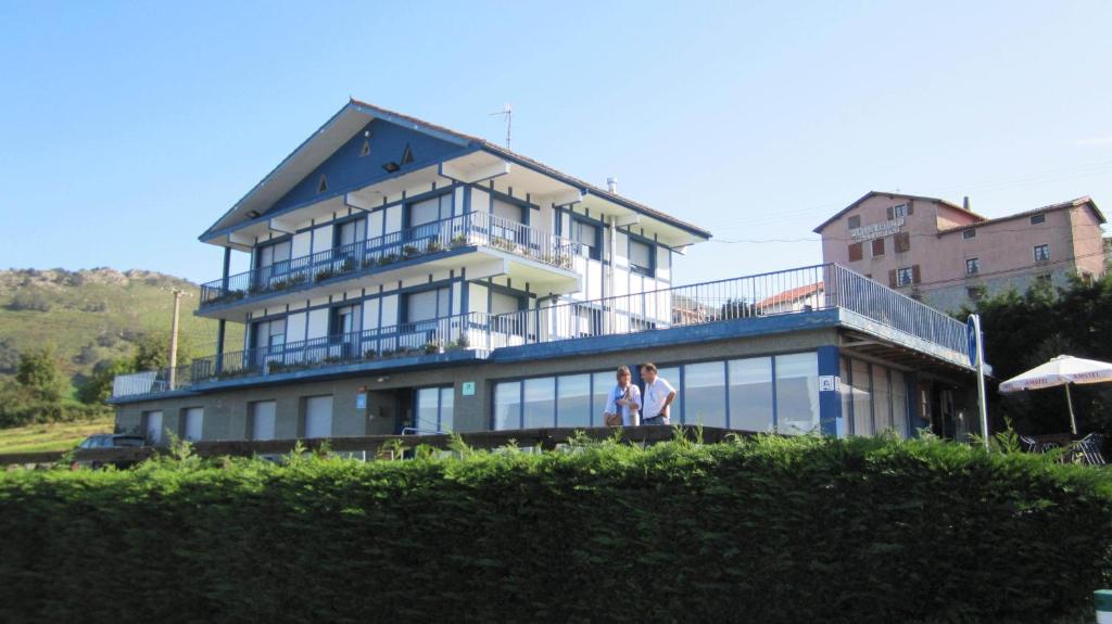 a woman standing in front of a house at Hotel Kanala in Deba