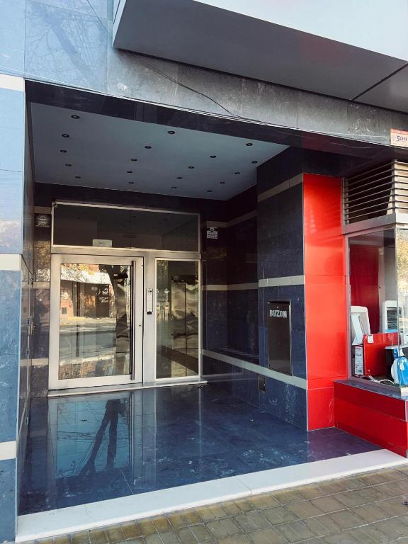 a reflection of a person walking outside of a building at Departamento Premiun Victoria I in San Juan