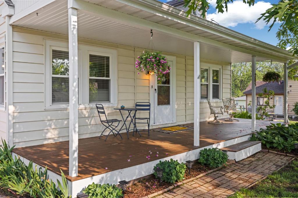 a front porch of a house with a table and chairs at The Gilded Cottage Entire Home in Winnebago