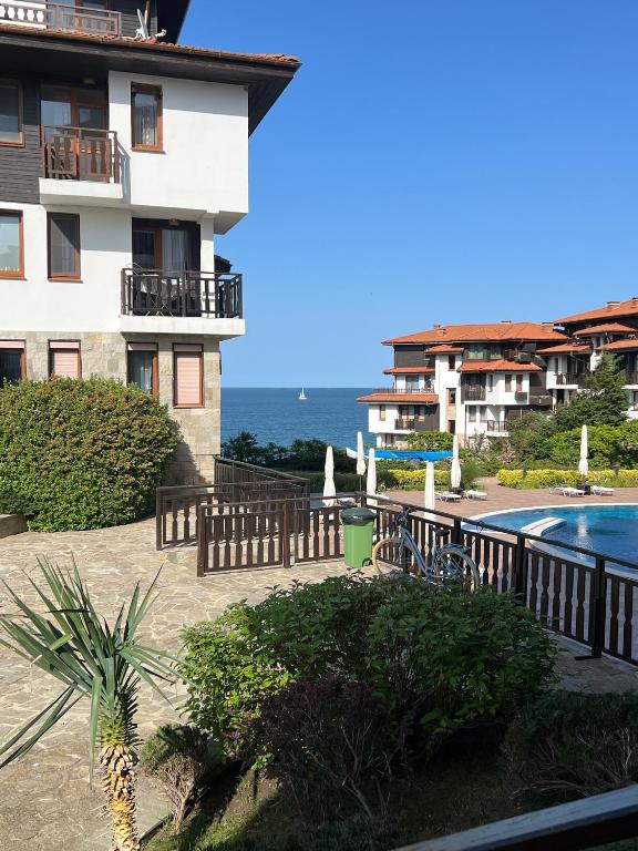 a view of a building and a swimming pool at Saint Thomas Holiday Village Condo in Sozopol