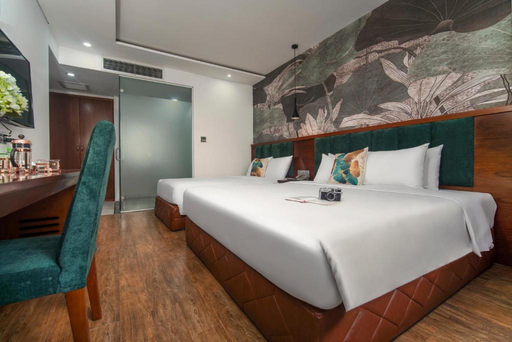 Postel nebo postele na pokoji v ubytování Pha Lê Hotel