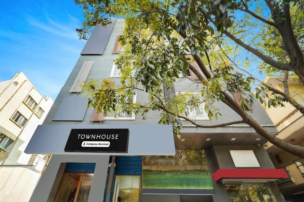 a building with a sign for a townhouse at Super Townhouse BTM Layout Near Madiwala Lake Formerly Q Rooms in Bangalore