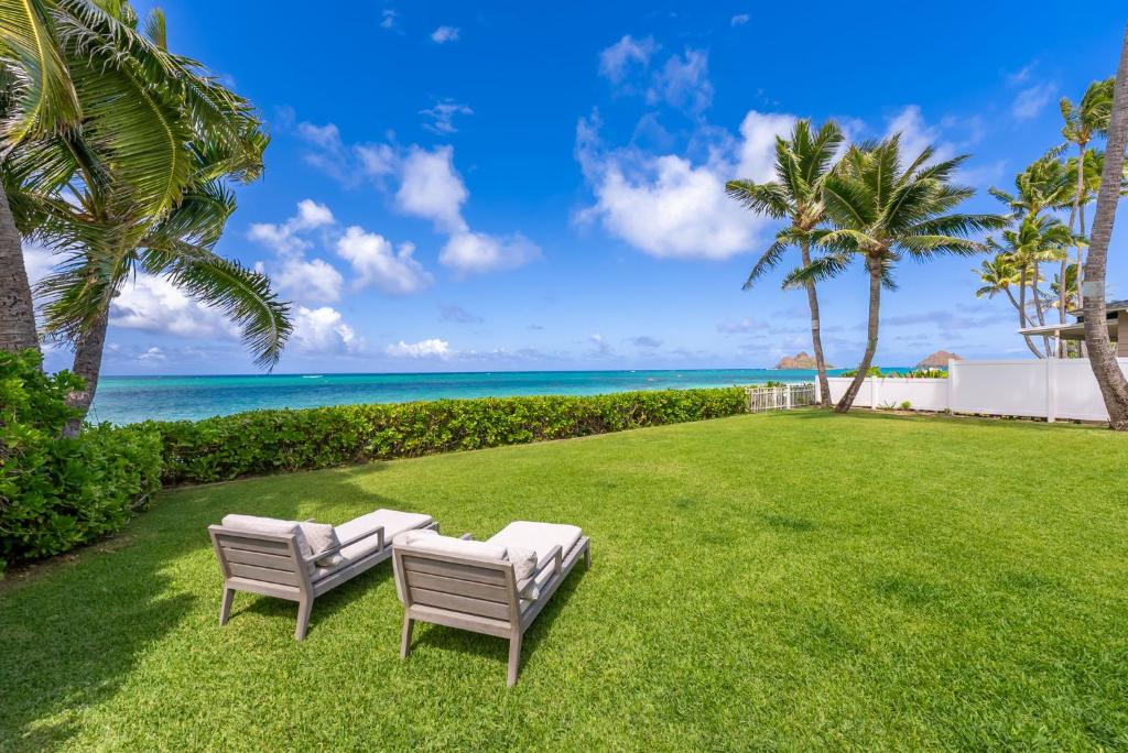 two chairs on a lawn with the ocean in the background at Lanikai Sunrise in Kailua