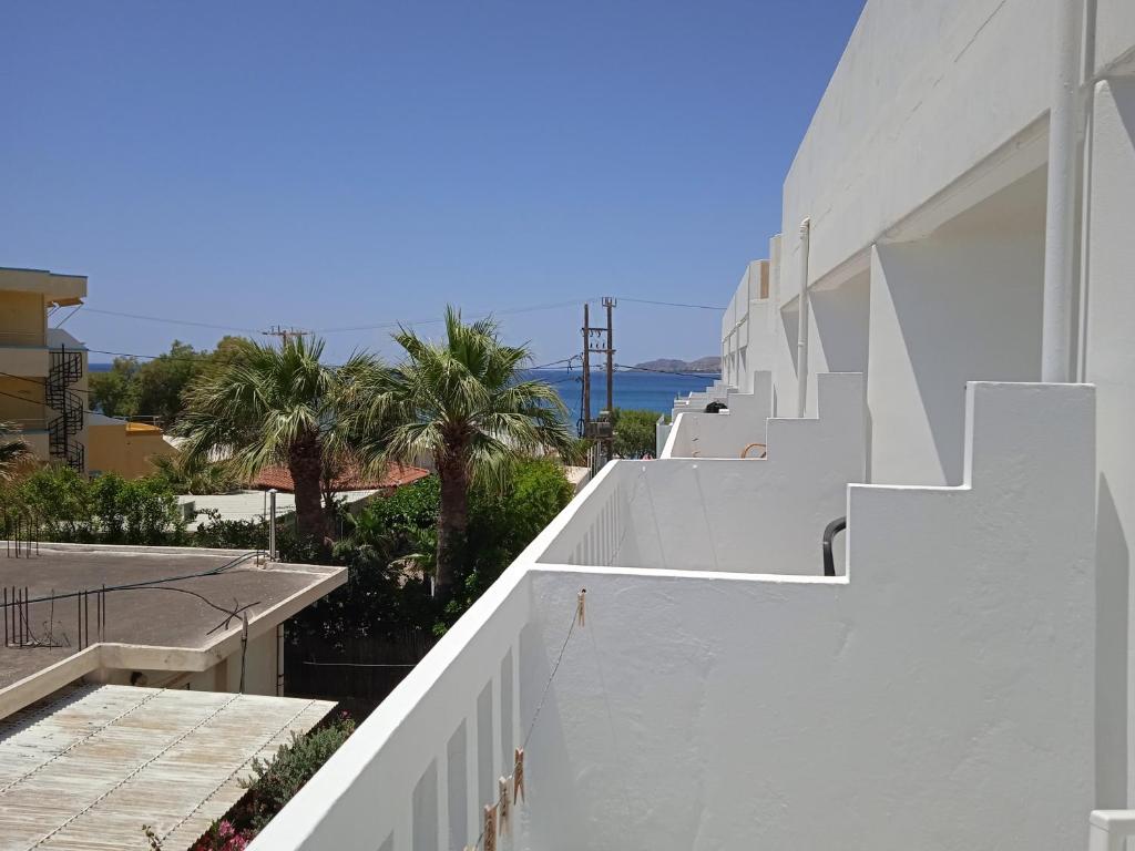 a white building with a view of the ocean at Pal Beach in Palaiochora