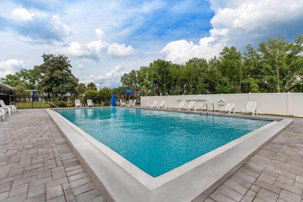 a large swimming pool with chairs at Quality Inn & Suites Ocala I-75 in Ocala