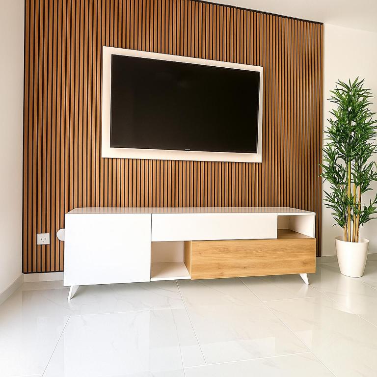 a living room with a television on a wall at Apartamento Maresía in Candelaria