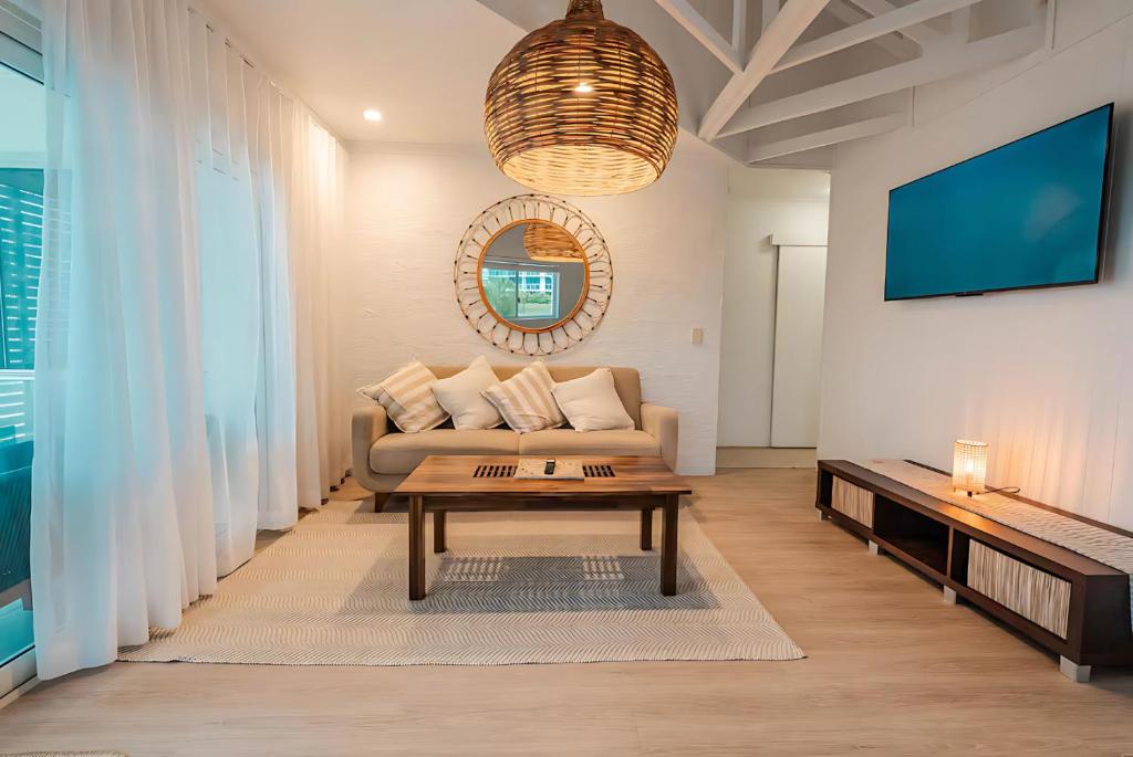 a living room with a couch and a table at Maroochydore Coastal Suite in Maroochydore