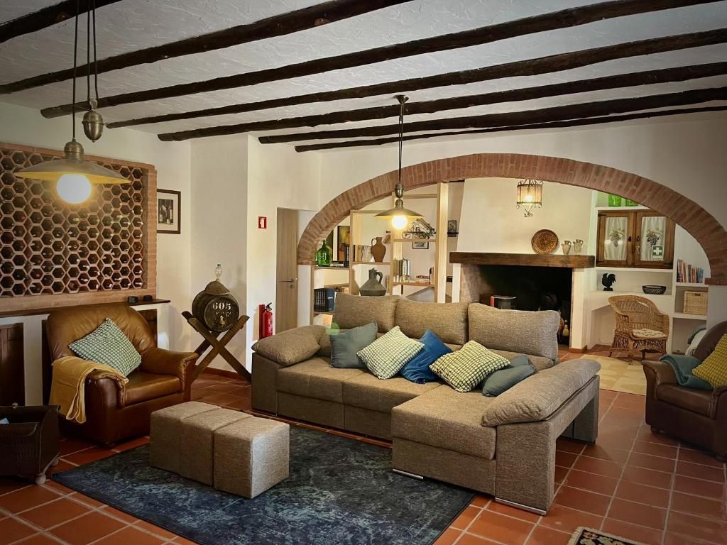 a living room with a couch and a fireplace at The Oak Tree Farm - Open Plan Layout by Portus Alacer in Rabaços
