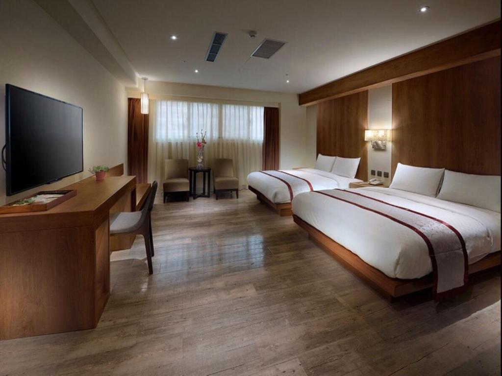 Postel nebo postele na pokoji v ubytování Cheng Pao Hotel