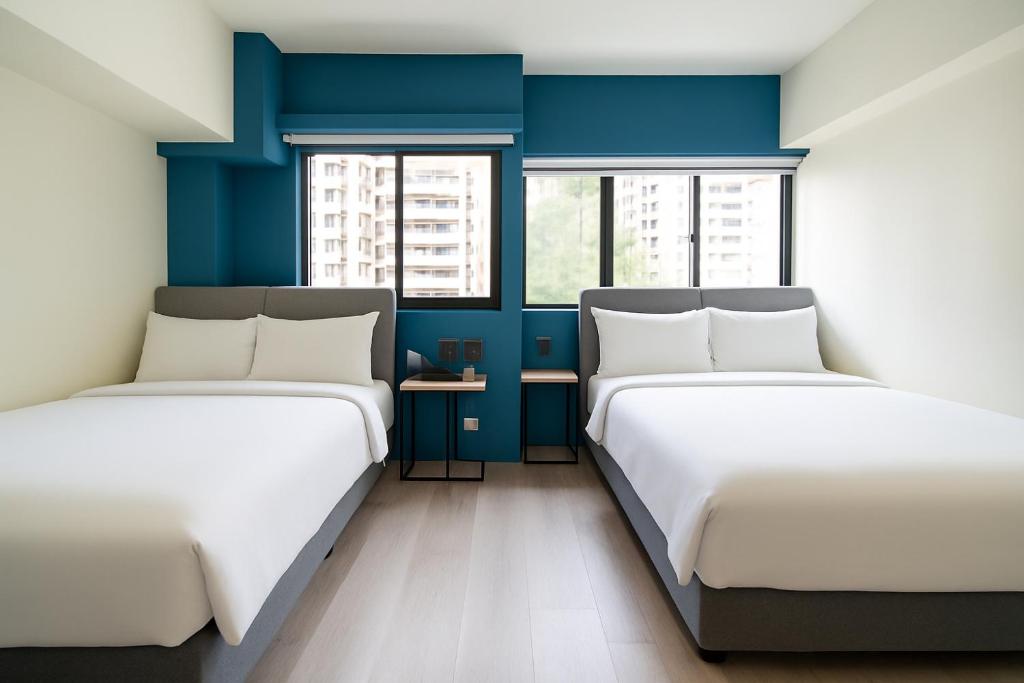 Postel nebo postele na pokoji v ubytování 星輝旅宿 MS Hotel 一中館
