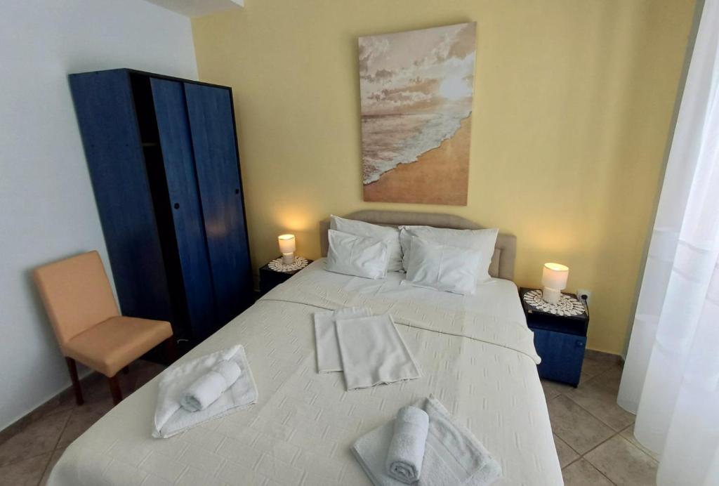 a bedroom with a bed with two towels on it at Apartments Mitrovići Miločer in Sveti Stefan