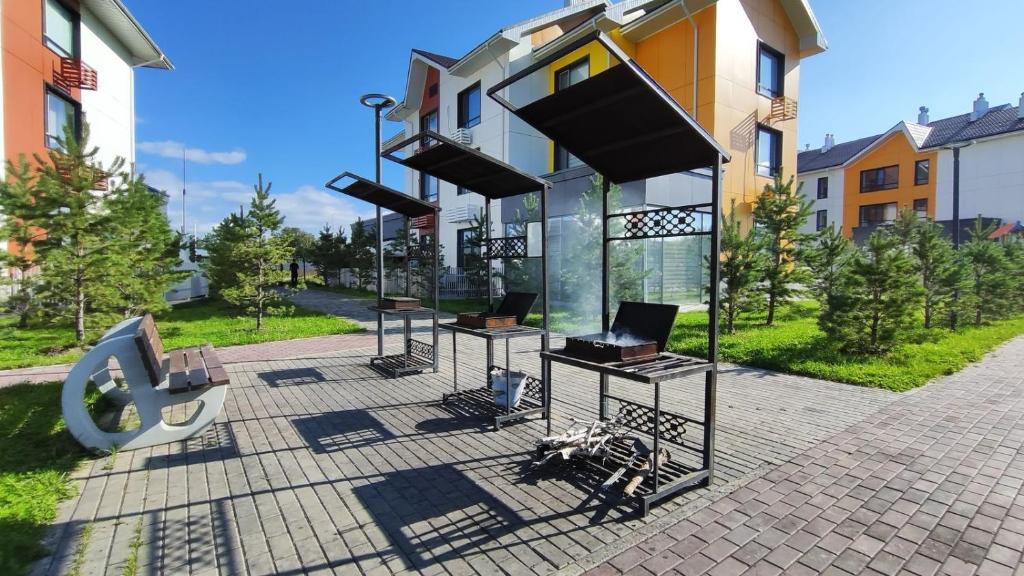 a building with someitures on a sidewalk next to a building at BURABAY Promenade Solo in Borovoye