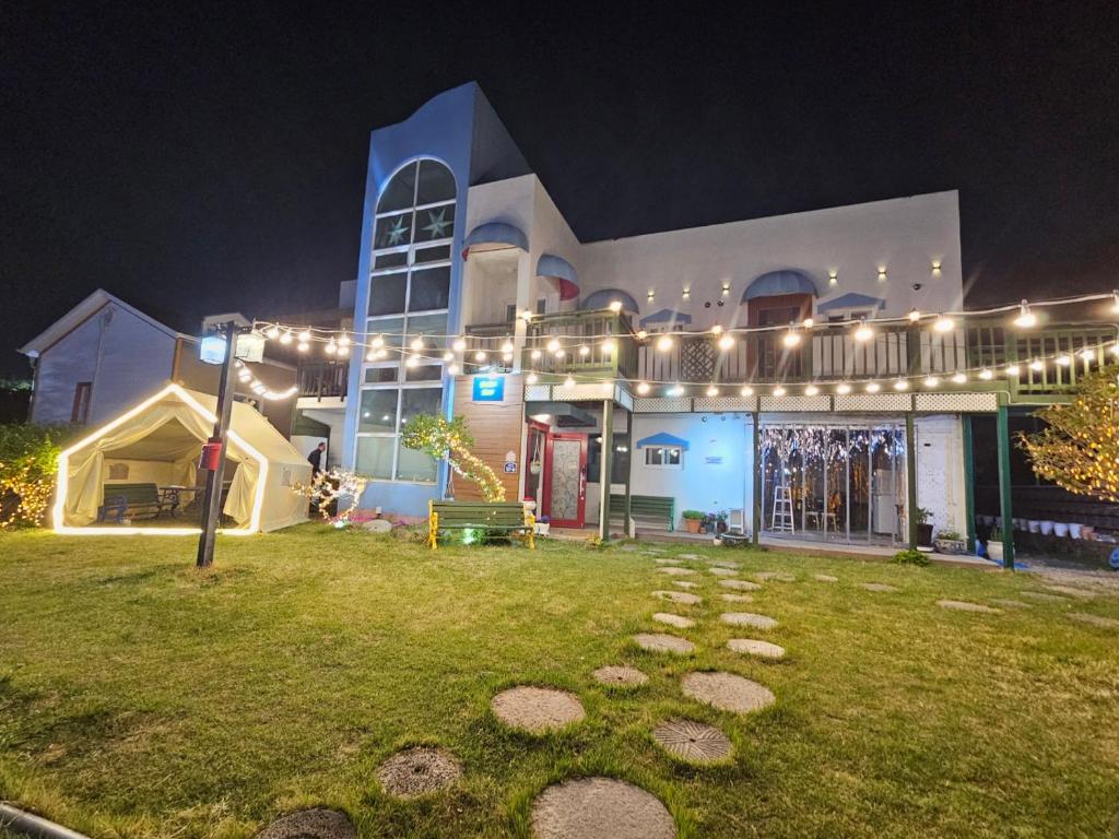 a large building with lights on it at night at Bellus-Rose Pension Gyeongju in Gyeongju