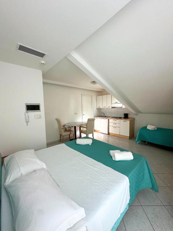 Postel nebo postele na pokoji v ubytování Hotel Ginevra e Residence