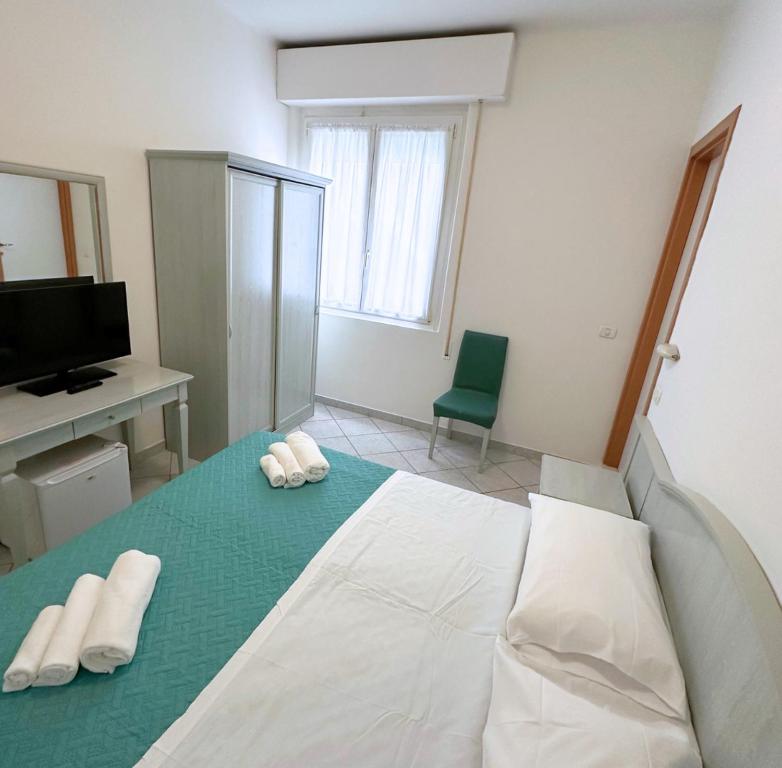 Postel nebo postele na pokoji v ubytování Hotel Ginevra e Residence