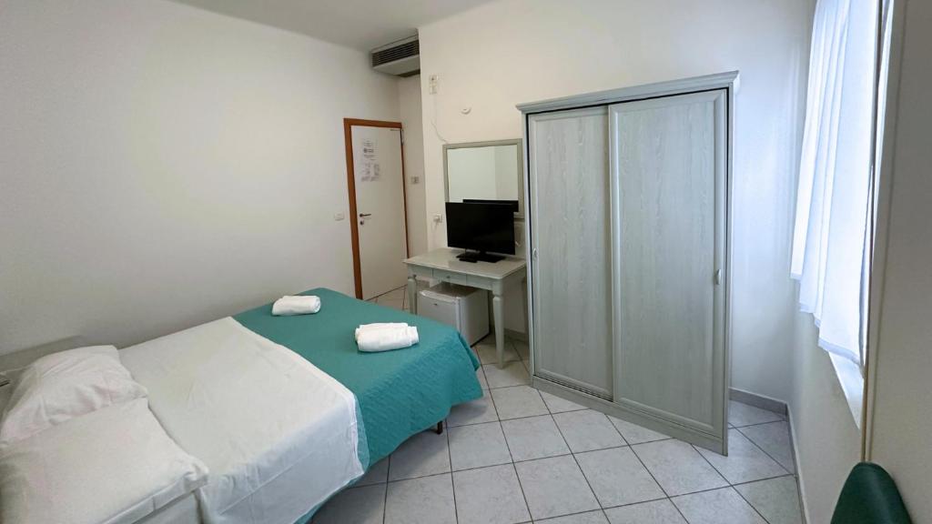 Postel nebo postele na pokoji v ubytování Hotel Ginevra e Residence