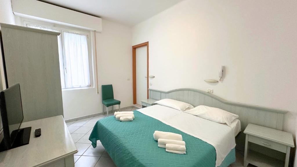 Postel nebo postele na pokoji v ubytování Hotel Ginevra e Residence